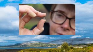 Dr Michelle Comber holding a turquoise and red glass bead found at the Rathgurreen Ringfort and believed to date from Early Medieval Ireland. Credit - Aengus McMahon