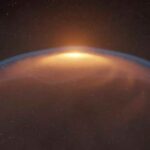 Artist’s impression of a protoplanetary disk distorted by a shock front created by an expanding bubble. Credit ALMA (ESO/NAOJ/NRAO), M. Aizawa et al