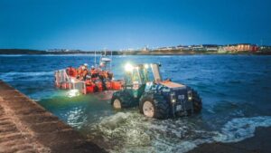 Tractor launching lifeboat into sea