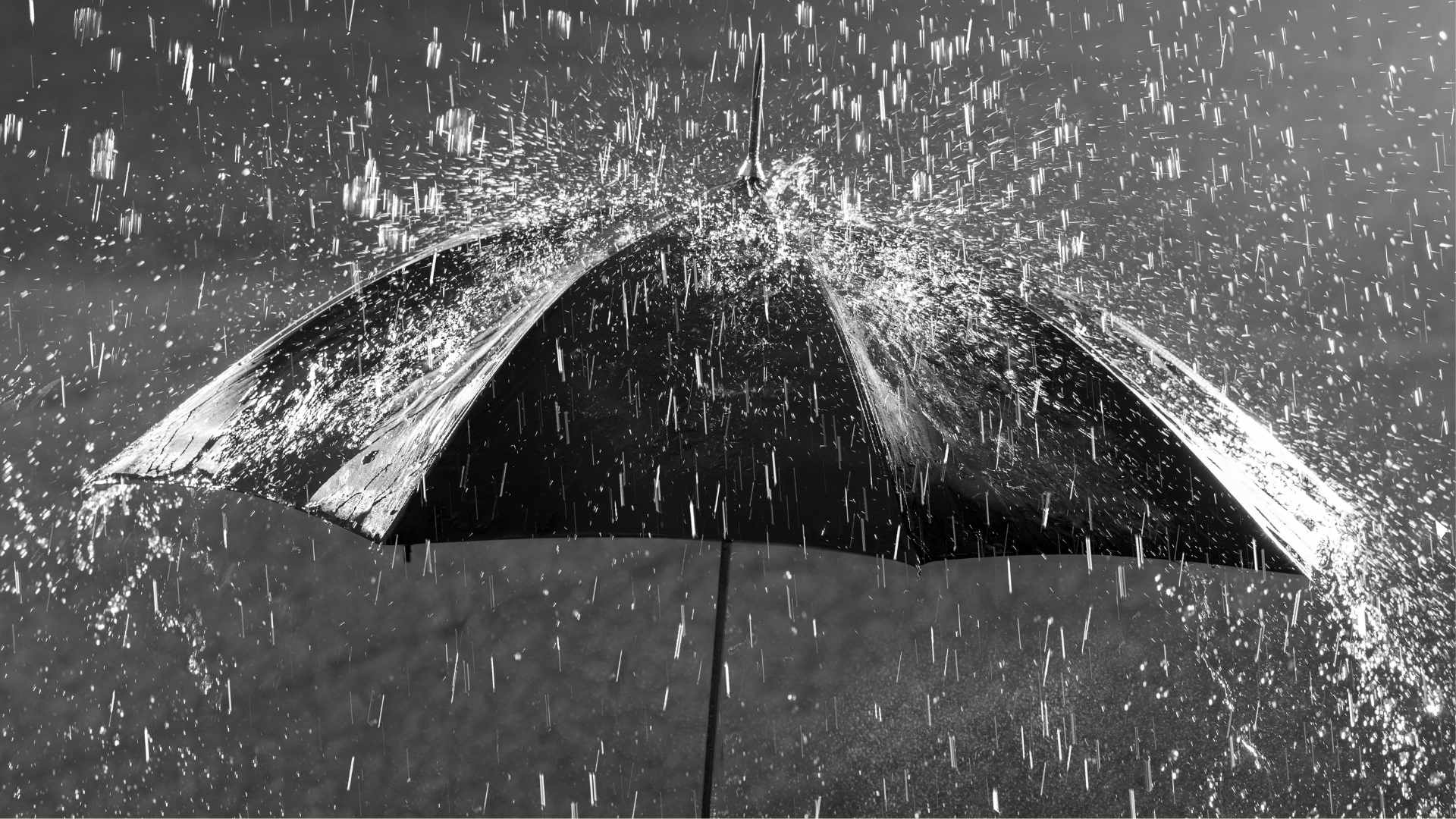 Heavy rain falling on an umbrella